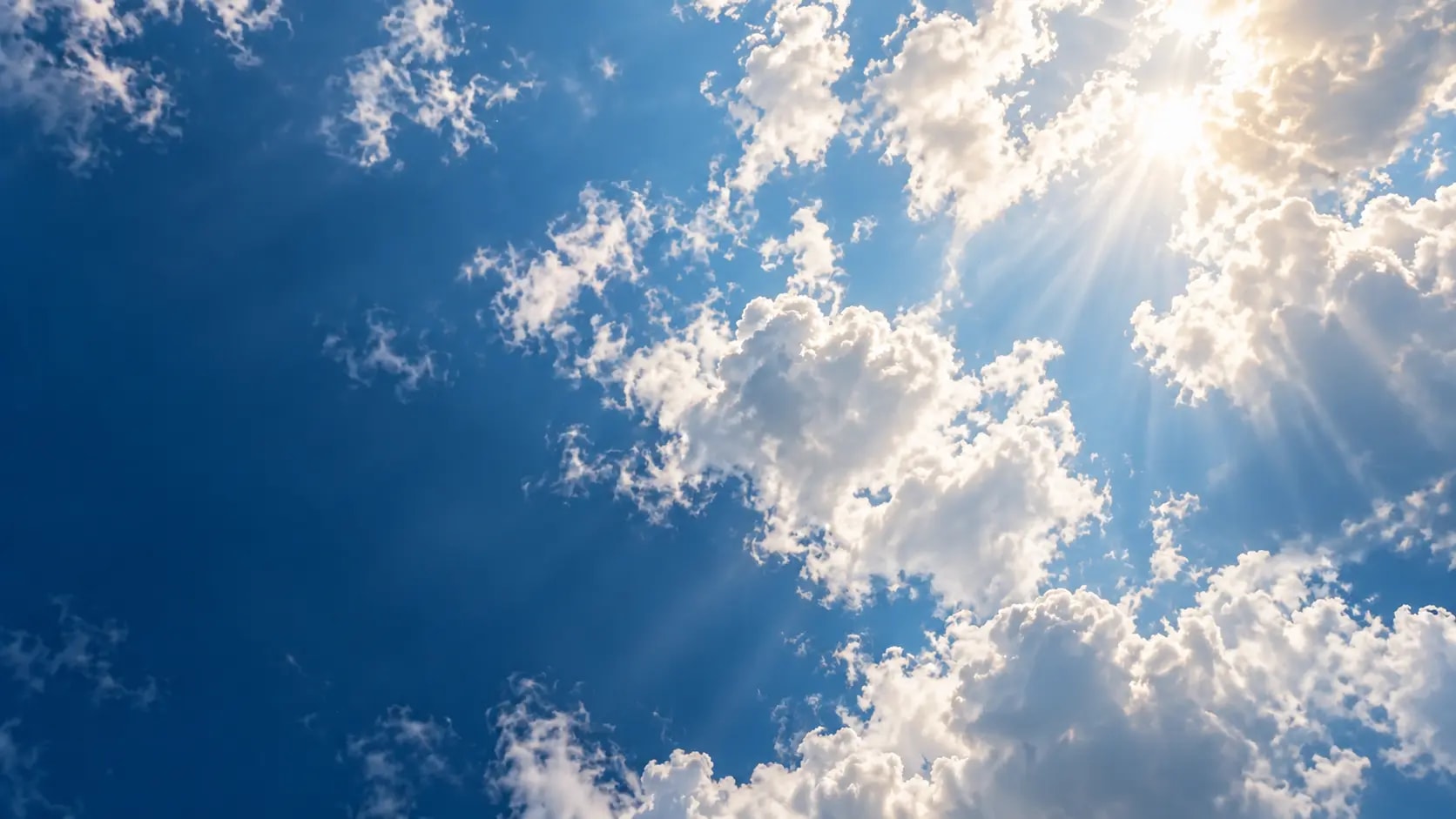 Sunlit clouds in a deep blue sky